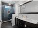 Modern bathroom featuring double sinks, large mirror, and glass-enclosed shower at 7698 Mount Carmel Dr, Orlando, FL 32835