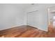 Bright bedroom features hardwood floors, a closet, and access to another room at 7698 Mount Carmel Dr, Orlando, FL 32835