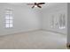 Empty bedroom showcasing neutral walls, large windows and ceiling fan at 7698 Mount Carmel Dr, Orlando, FL 32835