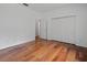 Bright bedroom features hardwood floors, a closet, and access to another room at 7698 Mount Carmel Dr, Orlando, FL 32835