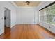 Spacious dining area showcasing hardwood floors, tray ceiling, and a large window for abundant natural light at 7698 Mount Carmel Dr, Orlando, FL 32835