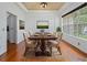 Formal dining room boasts hardwood floors, elegant chandelier, and a large window offering ample natural light at 7698 Mount Carmel Dr, Orlando, FL 32835
