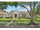 Inviting single-Gathering home with manicured lawn, stone steps, and large arched windows at 7698 Mount Carmel Dr, Orlando, FL 32835