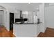 Modern kitchen with granite countertops, stainless steel appliances, and hardwood floors at 7698 Mount Carmel Dr, Orlando, FL 32835