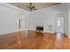 Open-concept living room featuring hardwood floors, fireplace, and high ceilings at 7698 Mount Carmel Dr, Orlando, FL 32835