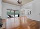 Spacious living room with hardwood floors and pool view through sliding doors at 7698 Mount Carmel Dr, Orlando, FL 32835