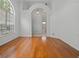 Bright living room with hardwood floors, large windows, and elegant architectural details and bathroom entrance at 7698 Mount Carmel Dr, Orlando, FL 32835