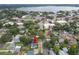 Aerial view of the home and neighborhood with mature trees and a lake in the distance at 814 Jefferson Ave, Lakeland, FL 33801