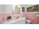 Pink bathroom with vanity, vintage fixtures, and bright lighting at 814 Jefferson Ave, Lakeland, FL 33801