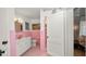 Charming pink-tiled bathroom with a sink, toilet, and shower stall at 814 Jefferson Ave, Lakeland, FL 33801