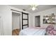 Bedroom featuring sliding barn door and light hardwood floors at 814 Jefferson Ave, Lakeland, FL 33801