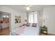 Bright bedroom with decor shelving, hardwood floors and view to bathroom at 814 Jefferson Ave, Lakeland, FL 33801