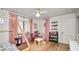 room with wood floors, a charming play area, and soft pink decor at 814 Jefferson Ave, Lakeland, FL 33801