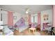 Adorable bedroom featuring wood floors, pink curtains and playful furnishings at 814 Jefferson Ave, Lakeland, FL 33801