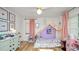 Charming bedroom with wood floors, a playful bed, and soft pink accents at 814 Jefferson Ave, Lakeland, FL 33801