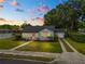 Charming home with a pink front door, well maintained lawn and convenient driveway access to the garage at 814 Jefferson Ave, Lakeland, FL 33801