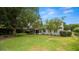 Well-maintained front yard with lush lawn, mature trees, and charming home exterior at 814 Jefferson Ave, Lakeland, FL 33801
