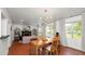 Open-concept living room featuring a modern light fixture and red tile flooring at 814 Jefferson Ave, Lakeland, FL 33801