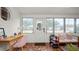 Versatile sunroom with tile flooring, home office set-up and plenty of windows at 814 Jefferson Ave, Lakeland, FL 33801