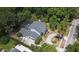 An aerial view showcasing the backyard pool, lush greenery, and the home's expansive driveway at 830 Miami Springs Dr, Longwood, FL 32779