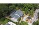 Stunning aerial view of a house with a pool, surrounded by lush greenery and a circular driveway at 830 Miami Springs Dr, Longwood, FL 32779
