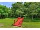 Beautiful backyard featuring a red wooden bridge with lush greenery and clear blue skies at 830 Miami Springs Dr, Longwood, FL 32779