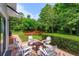 Backyard patio featuring outdoor seating and a charming red bridge at 830 Miami Springs Dr, Longwood, FL 32779