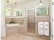Spa-like bathroom featuring a soaking tub and glass-enclosed shower, perfect for relaxation at 830 Miami Springs Dr, Longwood, FL 32779