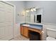 Well-lit bathroom featuring blue walls, a granite countertop, and an expansive mirror at 830 Miami Springs Dr, Longwood, FL 32779