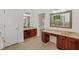 Bathroom boasting a double vanity, granite countertops, dark cabinets, and tile floors at 830 Miami Springs Dr, Longwood, FL 32779