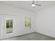 Bright bedroom featuring a door to outdoor area, window, fan, and neutral carpet at 830 Miami Springs Dr, Longwood, FL 32779