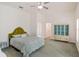 Well-lit bedroom featuring a bed, decor cabinet, large window, and ensuite bathroom with walk-in shower at 830 Miami Springs Dr, Longwood, FL 32779