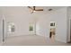 Spacious bedroom with neutral carpet, crown moulding, ceiling fan and two windows at 830 Miami Springs Dr, Longwood, FL 32779