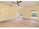 Bright, spacious bedroom with two windows and neutral carpet, providing ample natural light at 830 Miami Springs Dr, Longwood, FL 32779