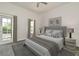 Well-lit bedroom with large bed, side tables, and a glass door that leads to the balcony at 830 Miami Springs Dr, Longwood, FL 32779