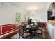 Sophisticated dining room featuring a modern chandelier, hardwood floors, and ample natural light at 830 Miami Springs Dr, Longwood, FL 32779