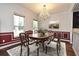 Dining room with wainscoting, chandelier, hardwood floor, windows and dining room set at 830 Miami Springs Dr, Longwood, FL 32779