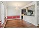 Elegant dining room with hardwood floors, wainscoting, and chandelier adjacent to kitchen at 830 Miami Springs Dr, Longwood, FL 32779