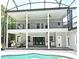 Exterior view of a two-story home with outdoor kitchen area, beautiful porch and pool at 830 Miami Springs Dr, Longwood, FL 32779