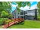 Exterior back of home featuring a red bridge, back patio and enclosed pool at 830 Miami Springs Dr, Longwood, FL 32779