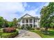 Elegant home featuring a grand two-story entrance with white columns and meticulously landscaped front yard at 830 Miami Springs Dr, Longwood, FL 32779