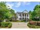 Stately home showcasing mature landscaping and a circular driveway leading to a welcoming entrance at 830 Miami Springs Dr, Longwood, FL 32779