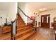 Grand foyer featuring hardwood floors, a staircase with iron railings, and an elegant chandelier at 830 Miami Springs Dr, Longwood, FL 32779