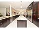 An open-concept kitchen featuring custom cabinets, granite countertops, stainless steel appliances, and pendant lighting at 830 Miami Springs Dr, Longwood, FL 32779