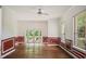 Bright living room with wood flooring, wainscoting, ceiling fan, and french doors to outdoor space at 830 Miami Springs Dr, Longwood, FL 32779
