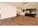 Spacious open concept living room with hardwood floors, flowing into kitchen with stainless steel appliances at 830 Miami Springs Dr, Longwood, FL 32779