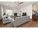 Comfortable living room with a fireplace, large window, plush seating, and access to a staircase at 830 Miami Springs Dr, Longwood, FL 32779