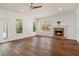 Bright living room features a fireplace, windows, and hardwood flooring at 830 Miami Springs Dr, Longwood, FL 32779