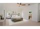 Staged main bedroom featuring neutral carpet, crown moulding, and en suite bathroom at 830 Miami Springs Dr, Longwood, FL 32779