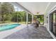 Screened-in patio featuring a pool, ceiling fan, and ample seating, perfect for outdoor entertainment at 830 Miami Springs Dr, Longwood, FL 32779